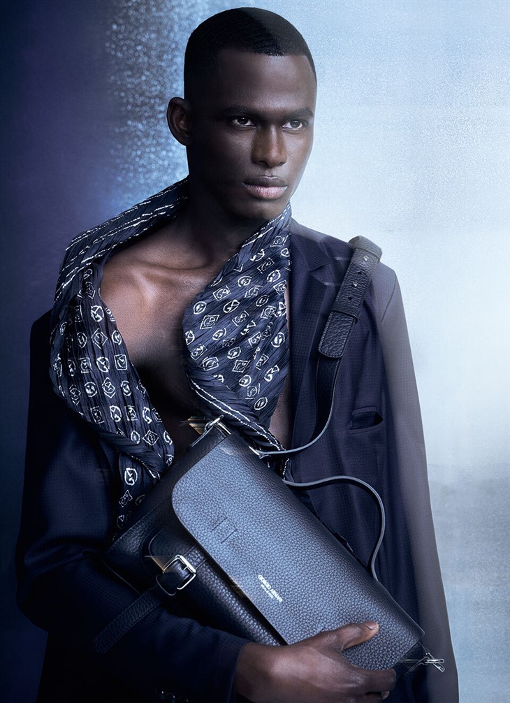 Man with Louis Vuitton Brown Backpack before Giorgio Armani